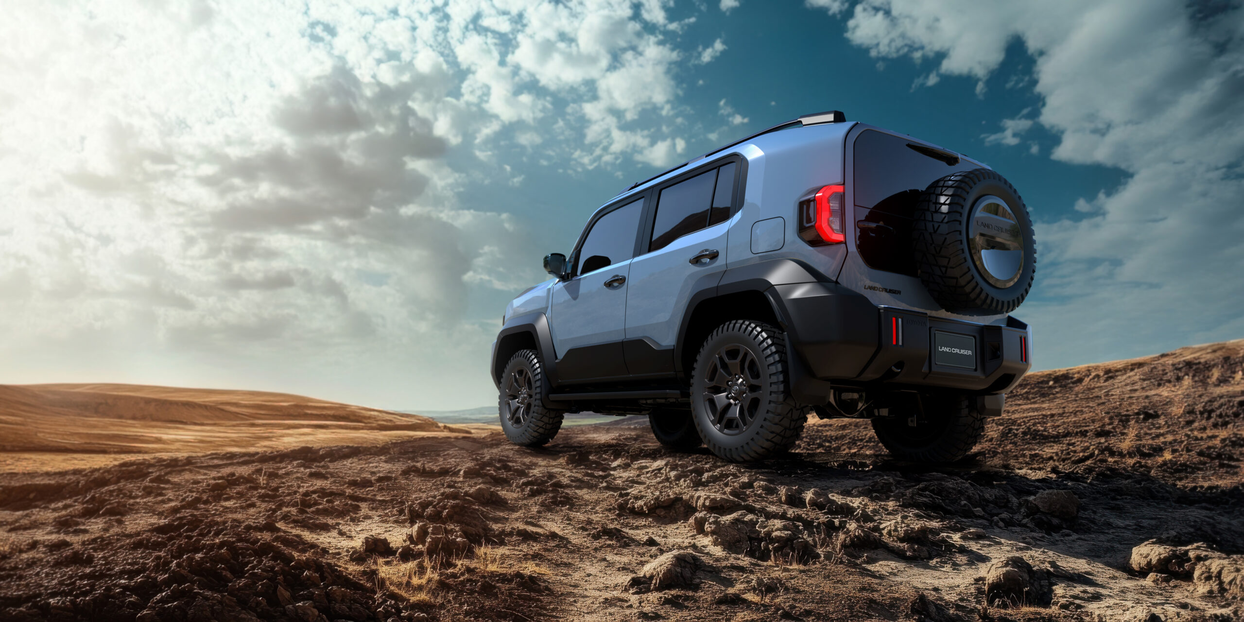 A white jeep is parked on a dirt road. The jeep has a large carg
